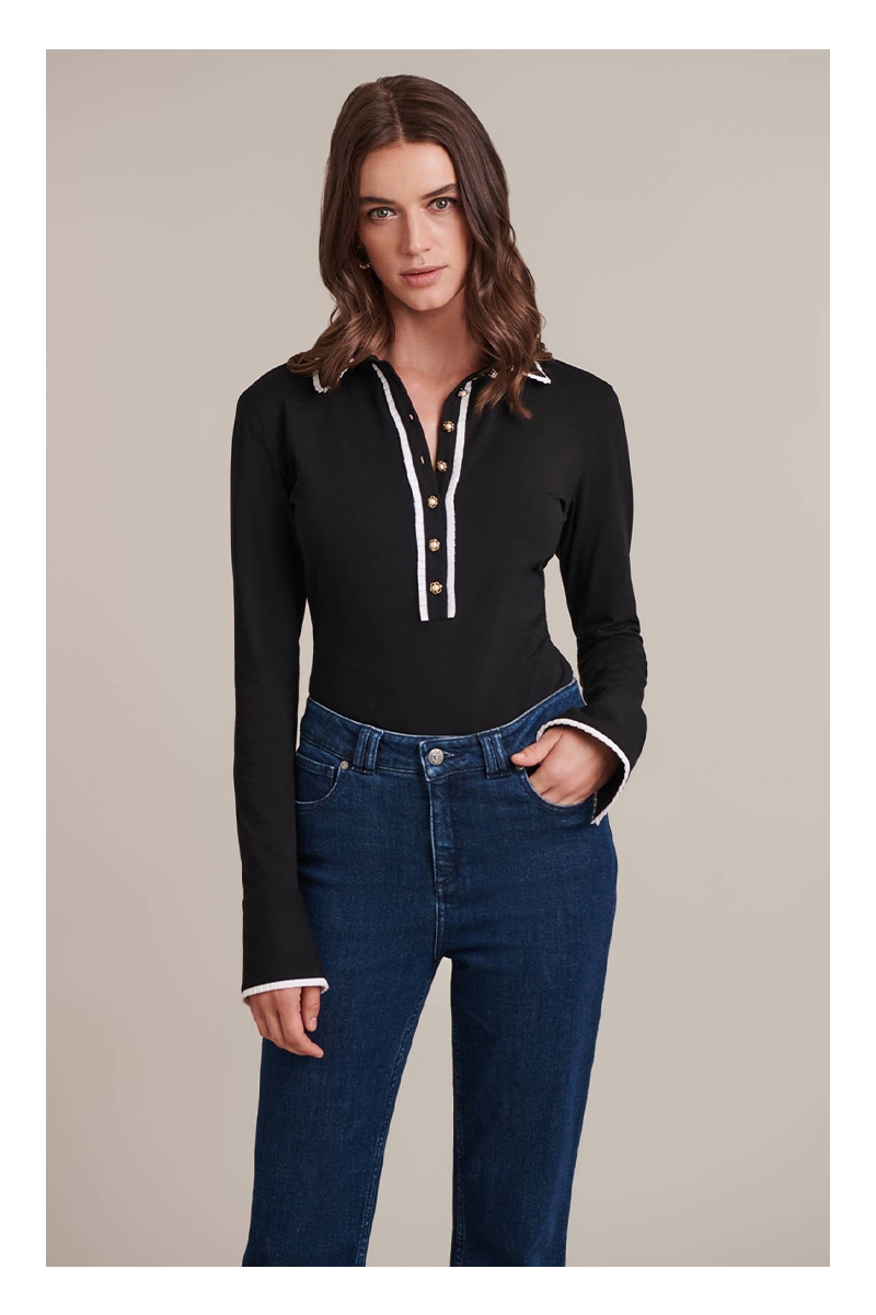 Discover the Faustine Black Long Sleeve Shirt With White Ruffle Detail Trims and Pearl Buttons from designer ANNE FONTAINE