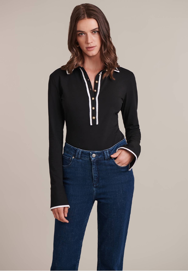 Discover the Faustine Black Long Sleeve Shirt With White Ruffle Detail Trims and Pearl Buttons from designer ANNE FONTAINE