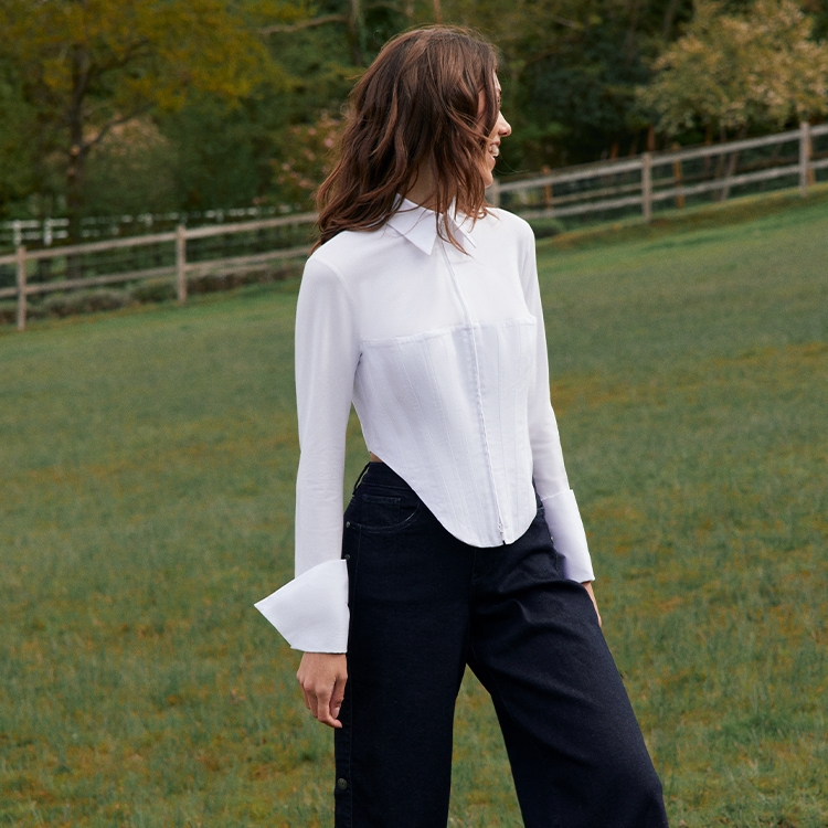 Discover the Eddie White Long Sleeve Zip Up Jersey Knit Shirt With Pique Corset Body from designer ANNE FONTAINE
