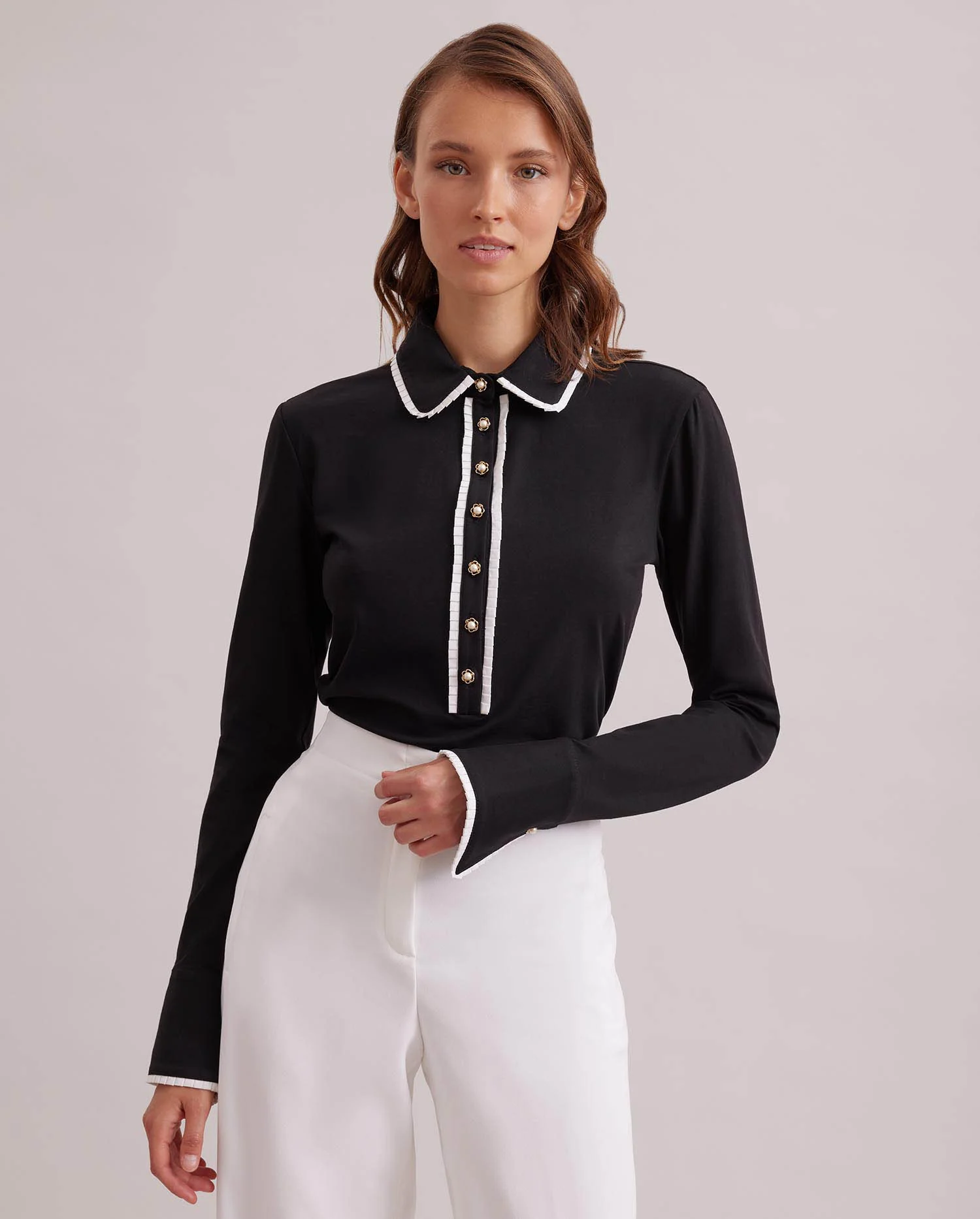 Discover The FAUSTINE black pima knit shirt with white piping and pearl buttons from ANNE FONTAINE.