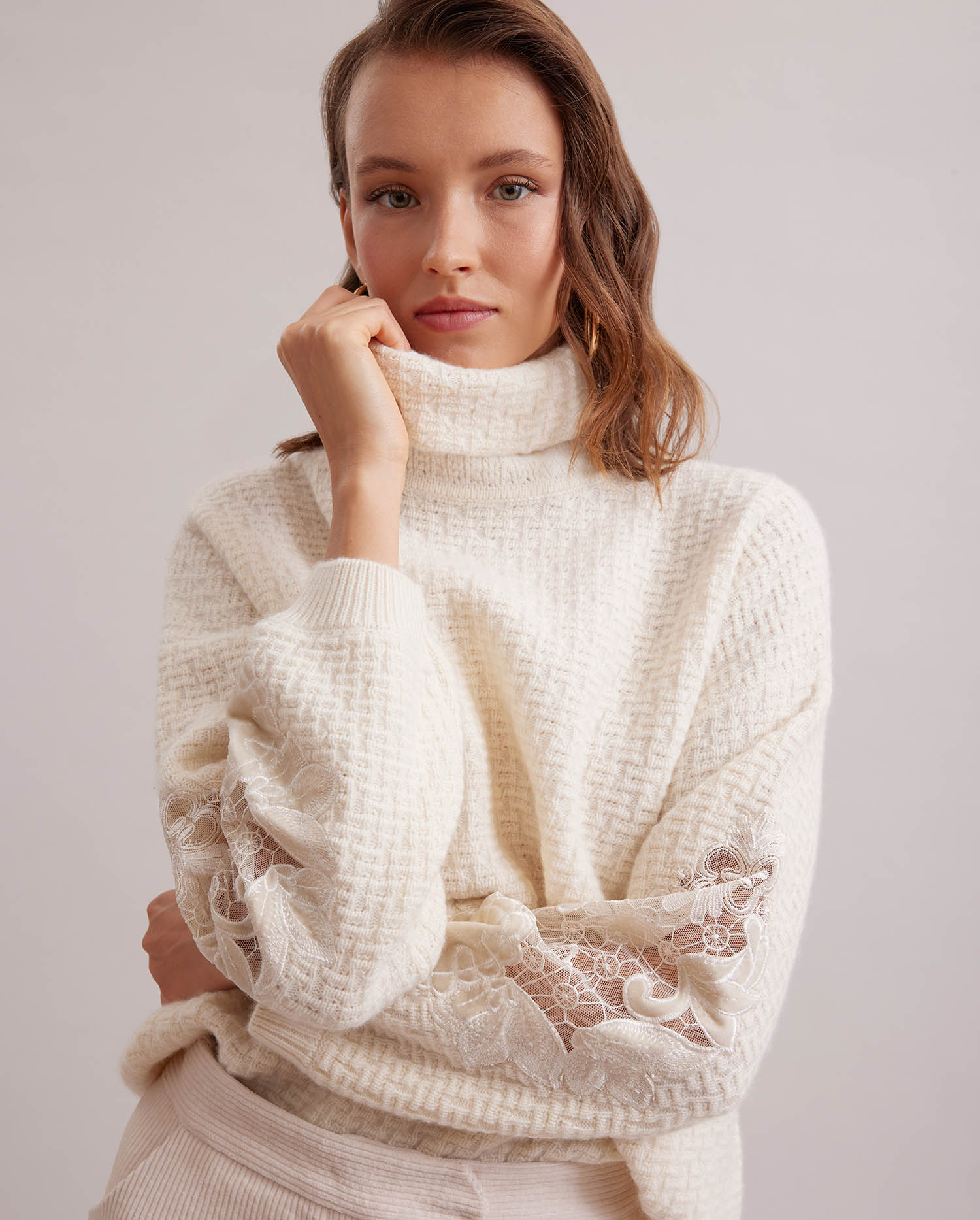 Discover the COLLEGE Cashmere waffle knit tunic sweater with sheer embroidered sleeves