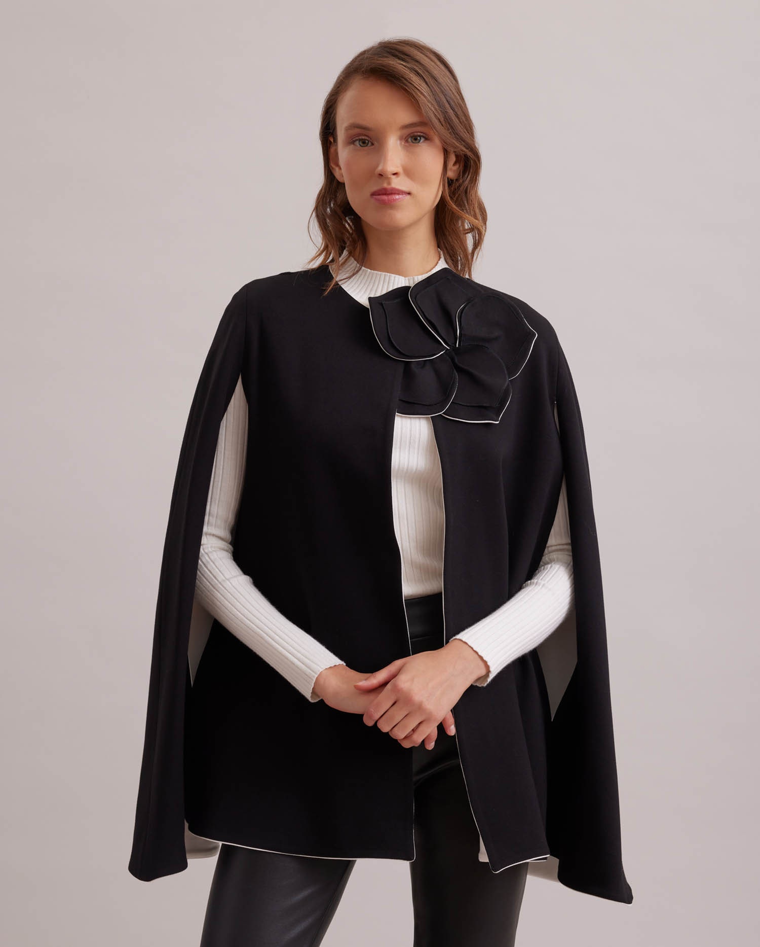 Discover The MANOLO Milano cape with arm hole openings and removable flower pin from ANNE FONTAINE