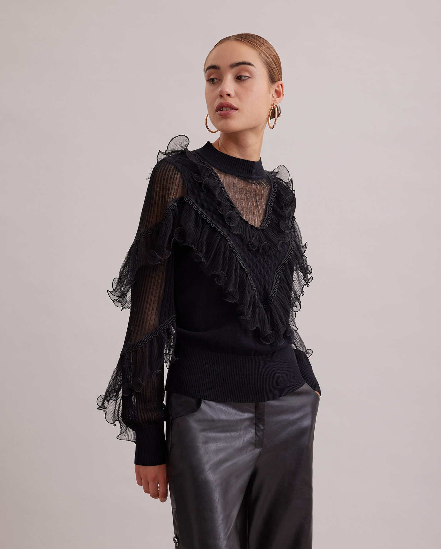 Discover The OEUVRE Long sleeve black knit with sheer details and cascading ruffles from ANNE FONTAINE