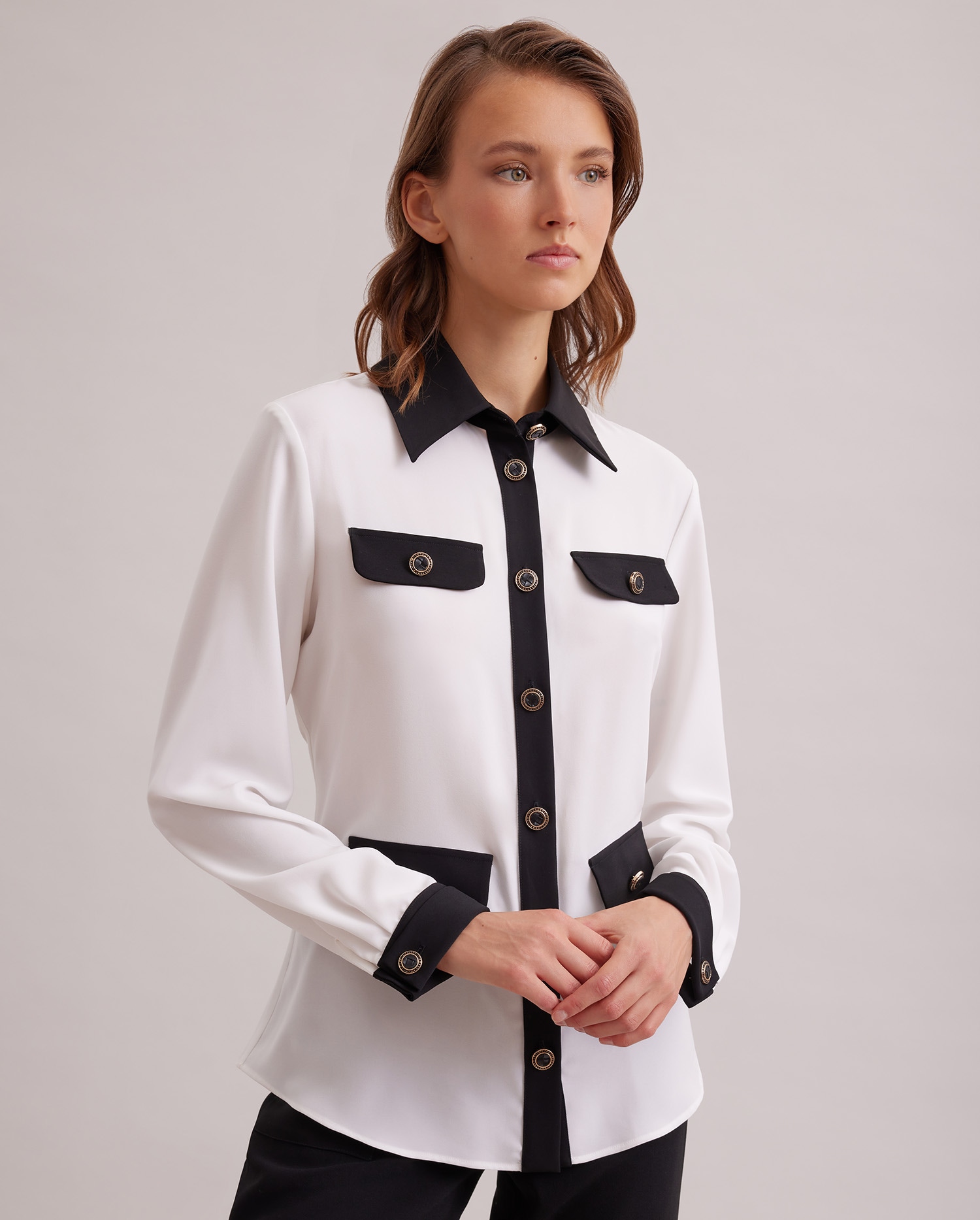 Discover the SANDEAU Long sleeve white shirt with black contrast trims and large button details from ANNE FONTAINE