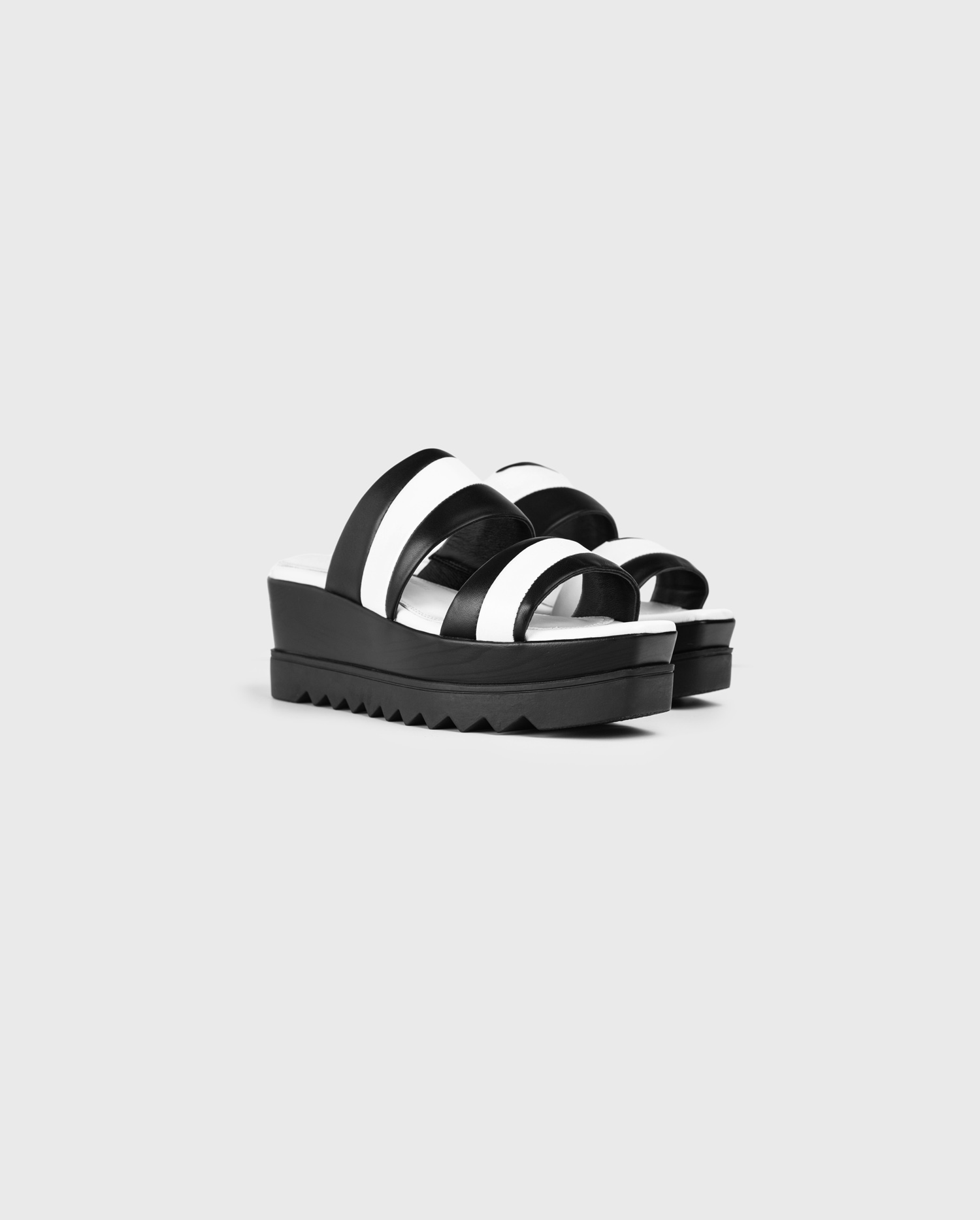 Discover The ARISTA Monochrome flatforms with dual straps from ANNE FONTAINE