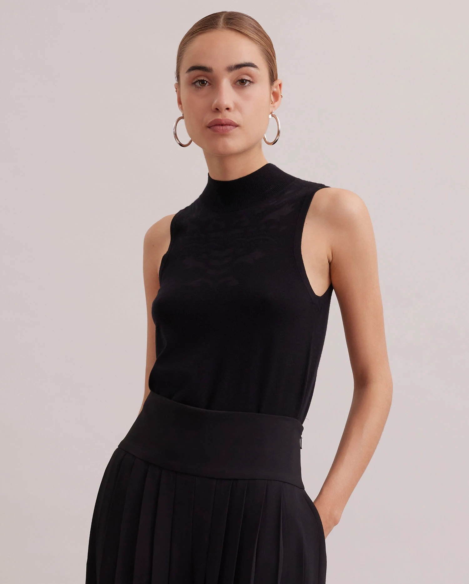 Discover The KATIXA Sleeveless Black Mockneck Knit from ANNE FONTAINE