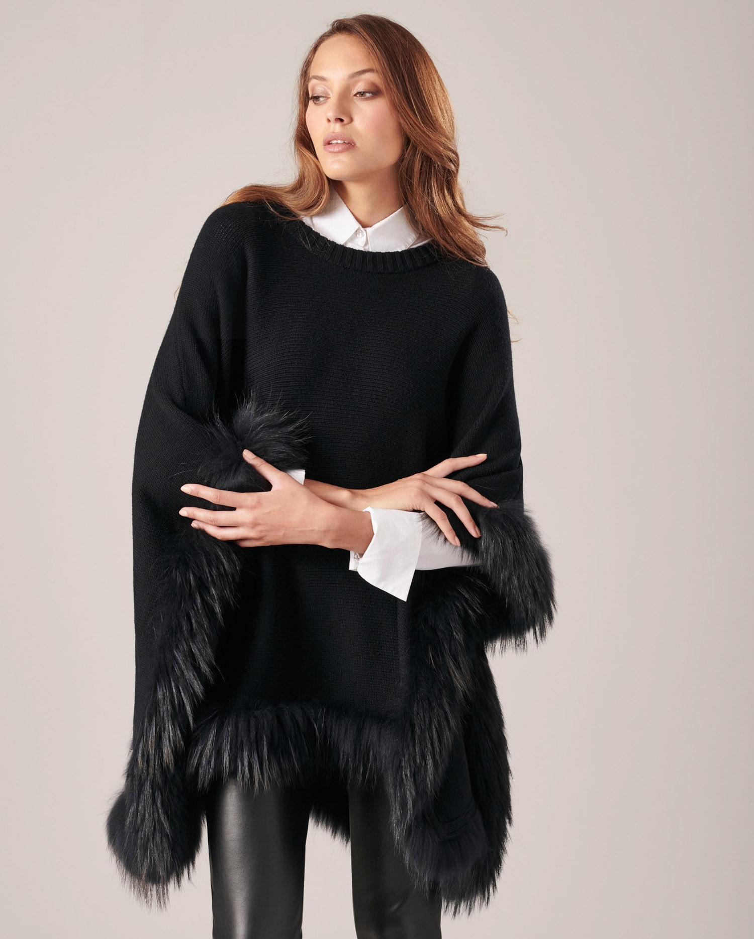 Discover The LOIC Knitted Poncho With Fur Trim in Black from ANNE FONTAINE