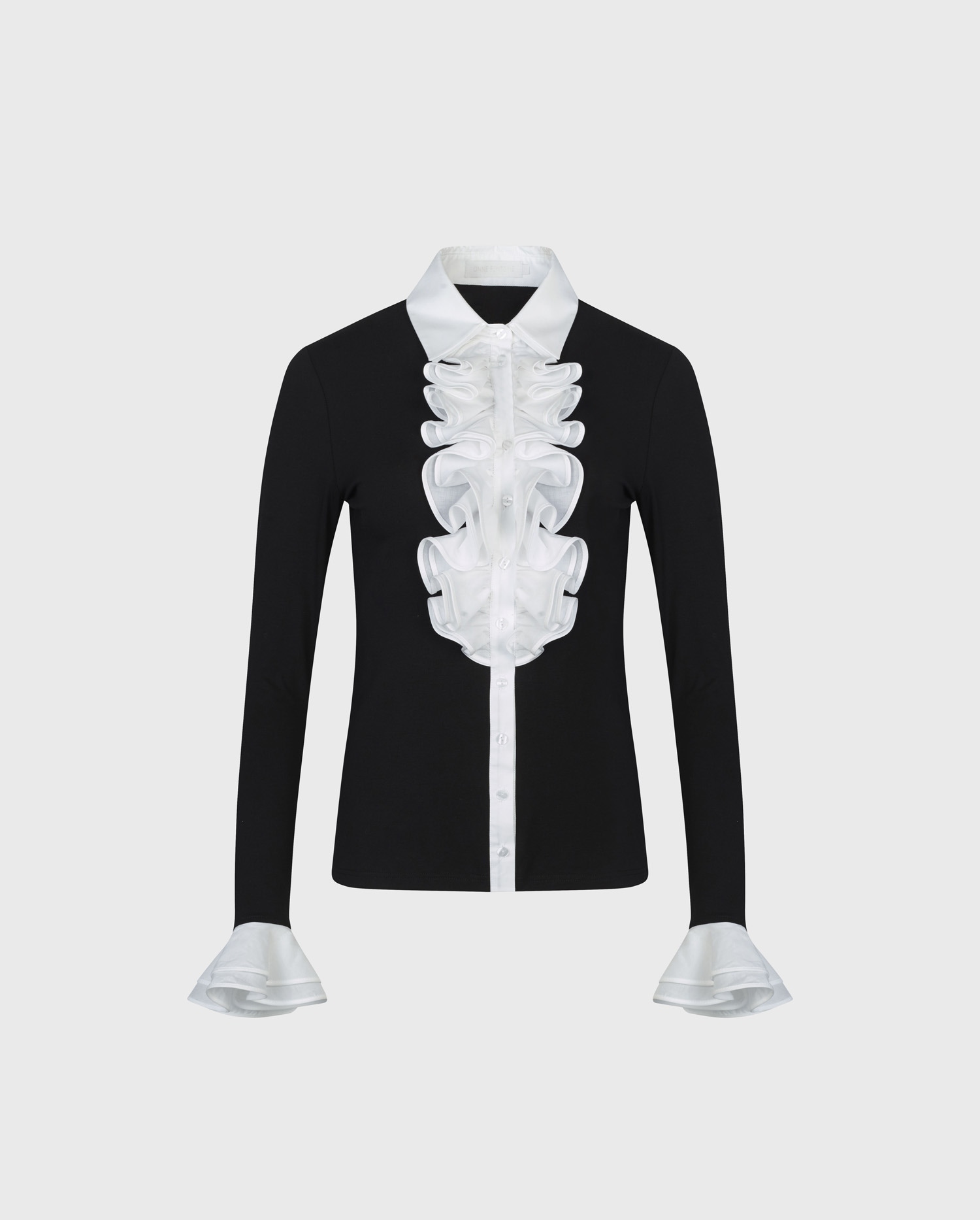 Discover The PATSY Black jersey shirt with white ruffle details from ANNE FONTAINE