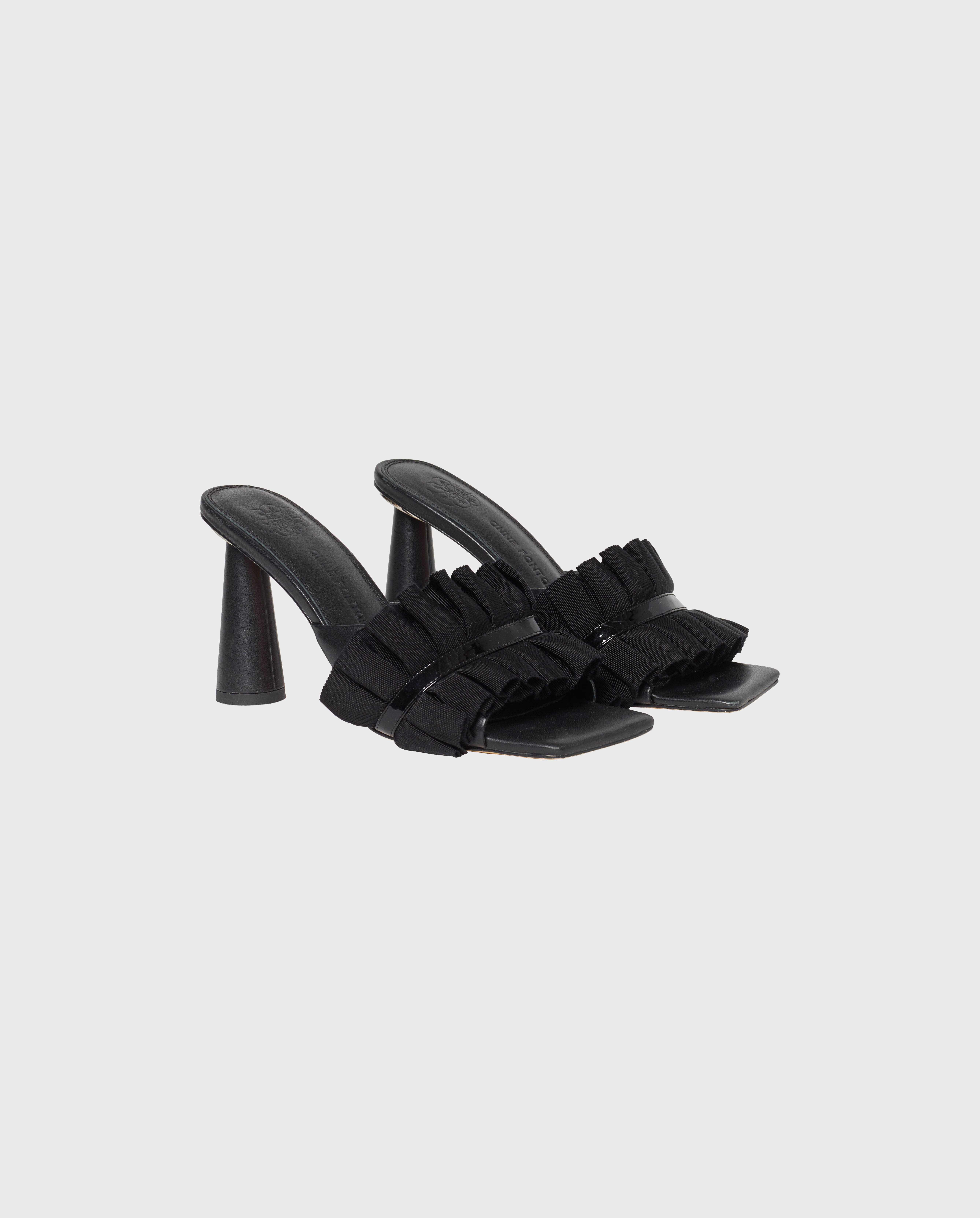 Discover the MUXICA Black Leather Slides With Ruffle Details from designer ANNE FONTAINE