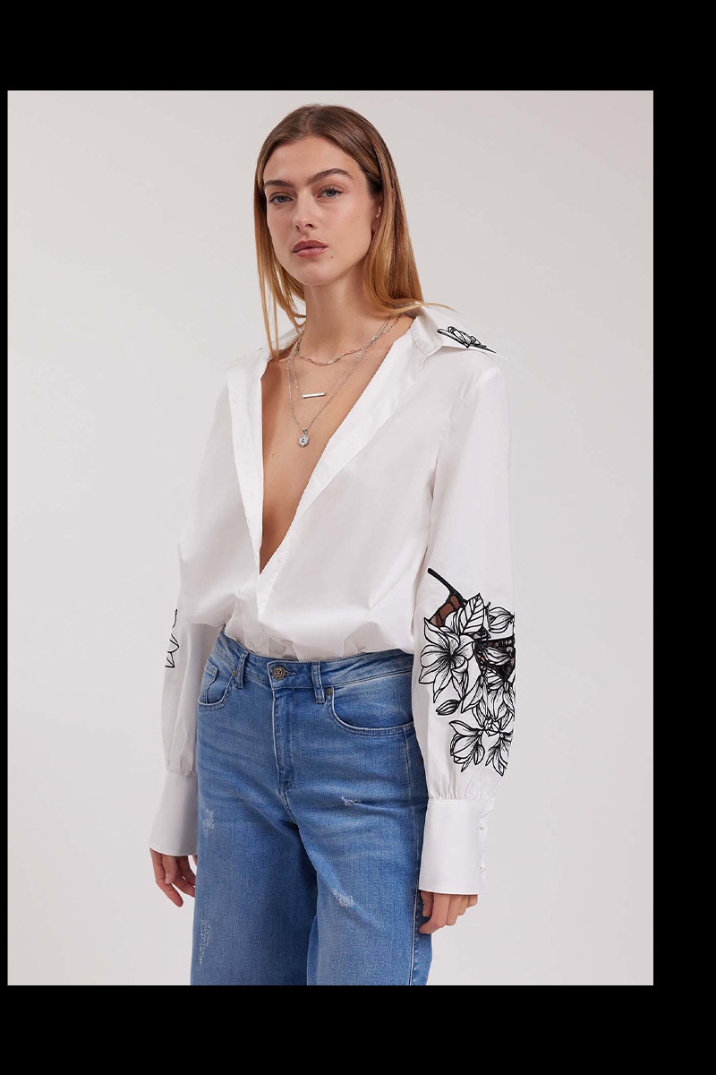 Discover the LEONIE White Long Sleeve Cotton Poplin Shirt With Black Embroidered Flowers from designer ANNE FONTAINE