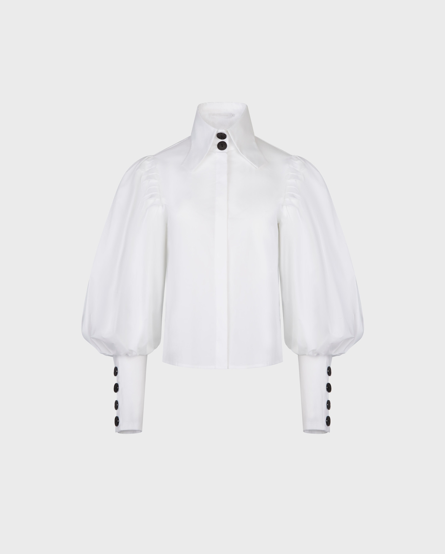 Discover the NOHANT White Boxy Poplin Shirt With Bishops Sleeves and Black Button Details from ANNE FONTAINE