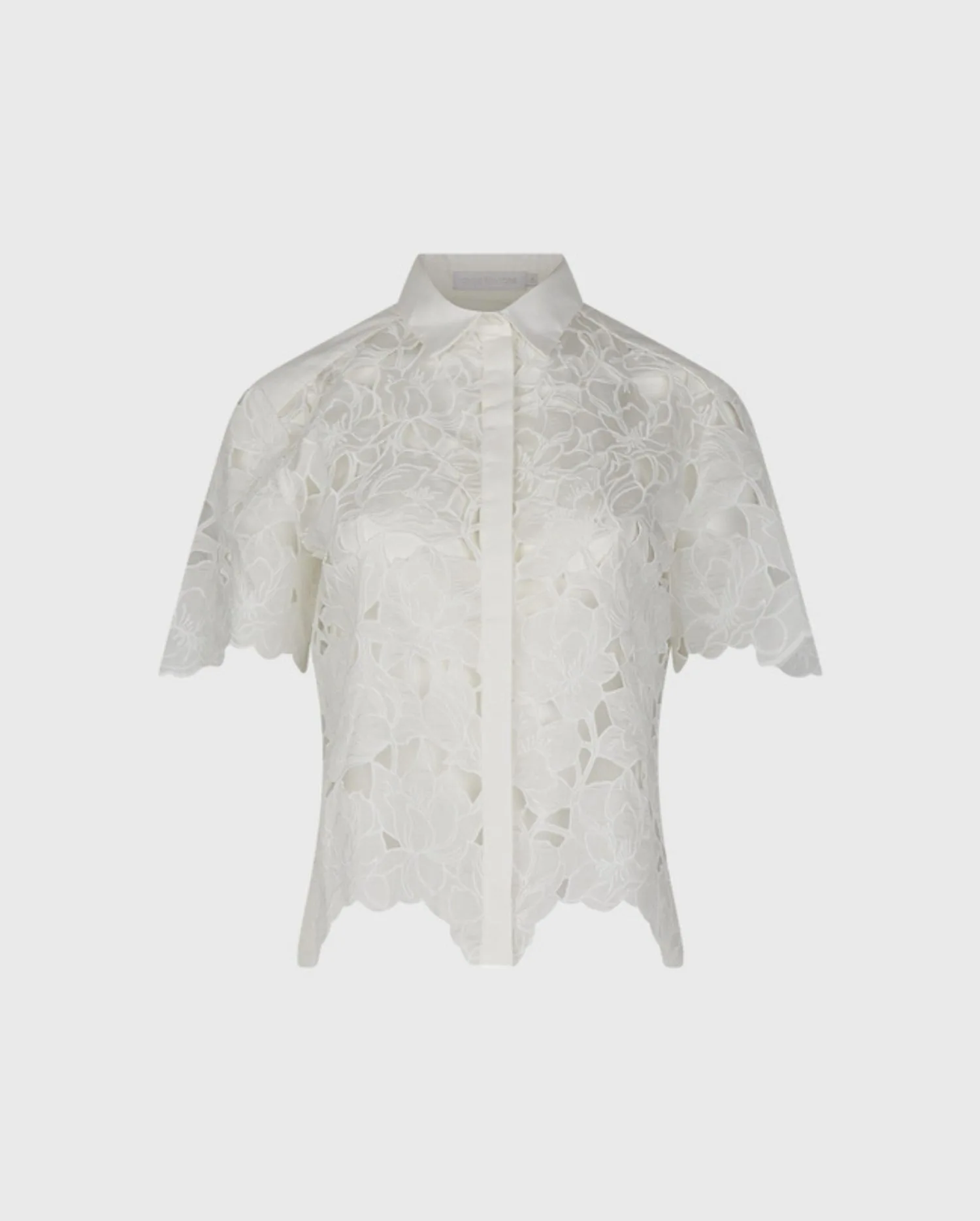 Discover the Eulalia White Short Sleeve Cropped Cotton Voile Embroidered Floral Button Down Shirt by designer ANNE FONTAINE.