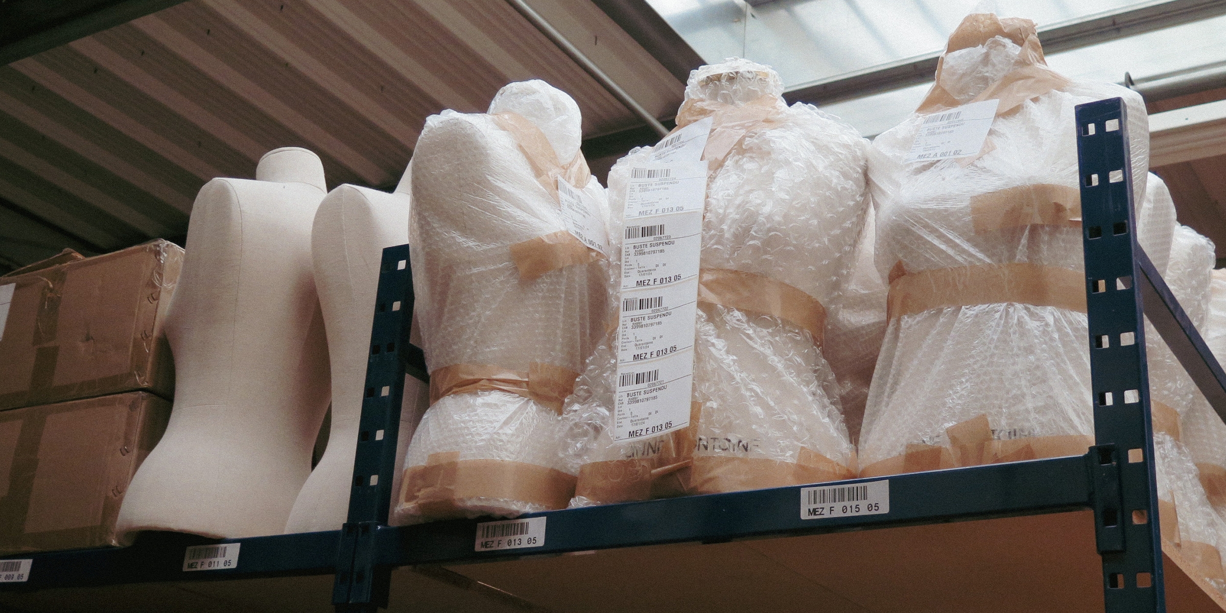 CLOSEUP OF MANNEQUINS IN WAREHOUSE
