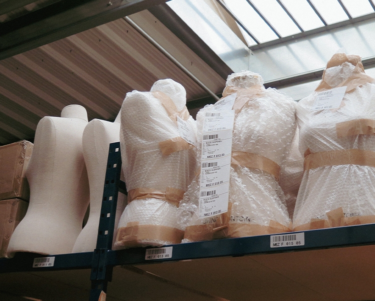 CLOSEUP OF MANNEQUINS IN WAREHOUSE