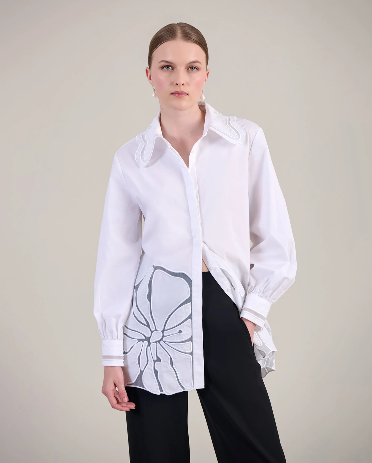 Discover the INGRID White Long Sleeve Poplin Tunic Length Shirt With Sheer Embroidered Flowers Along the Bottom Hem from designer Anne Fontaine