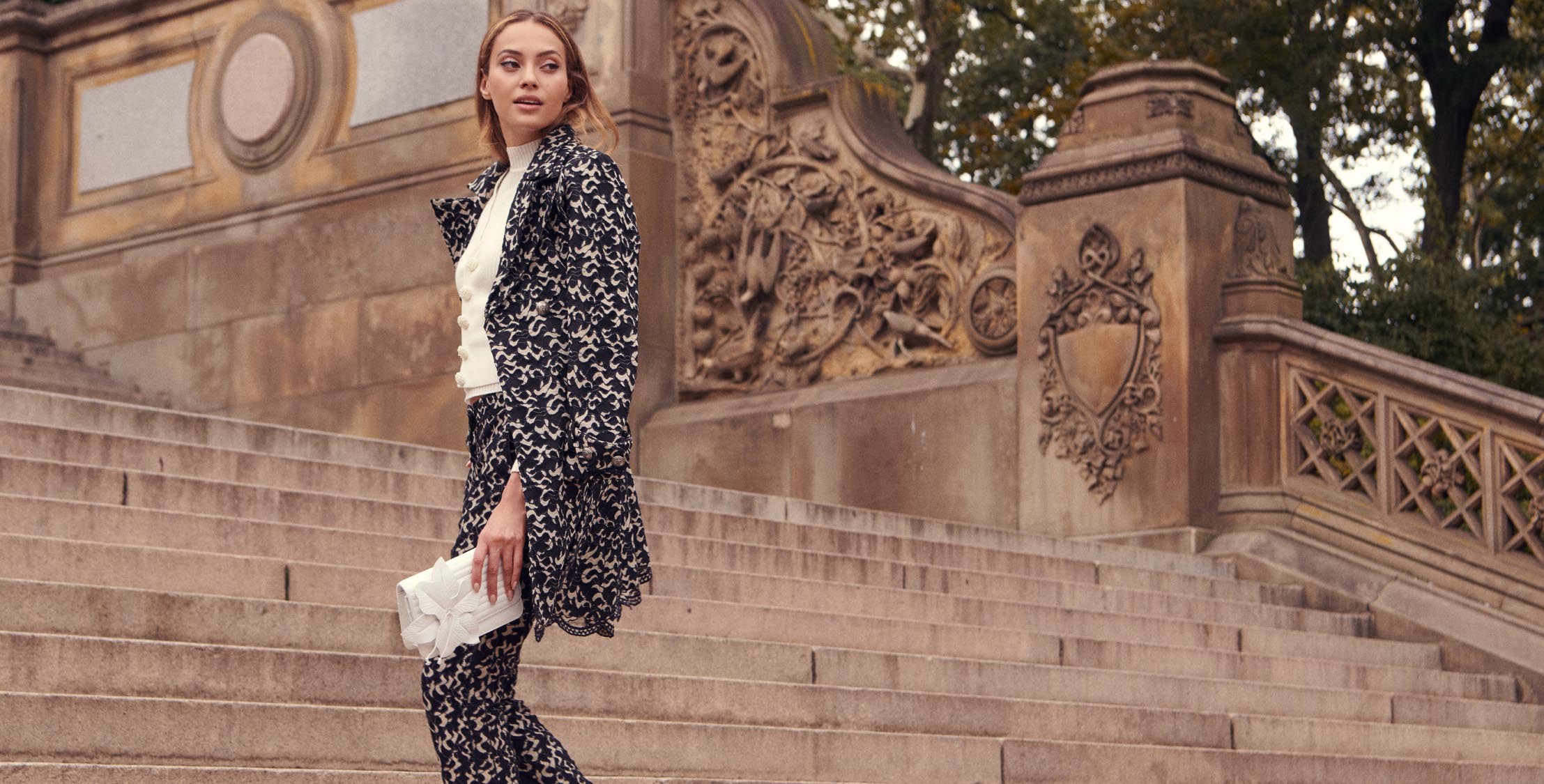 The VANOLO black and cream floral trench coat will make sure you arrive in style