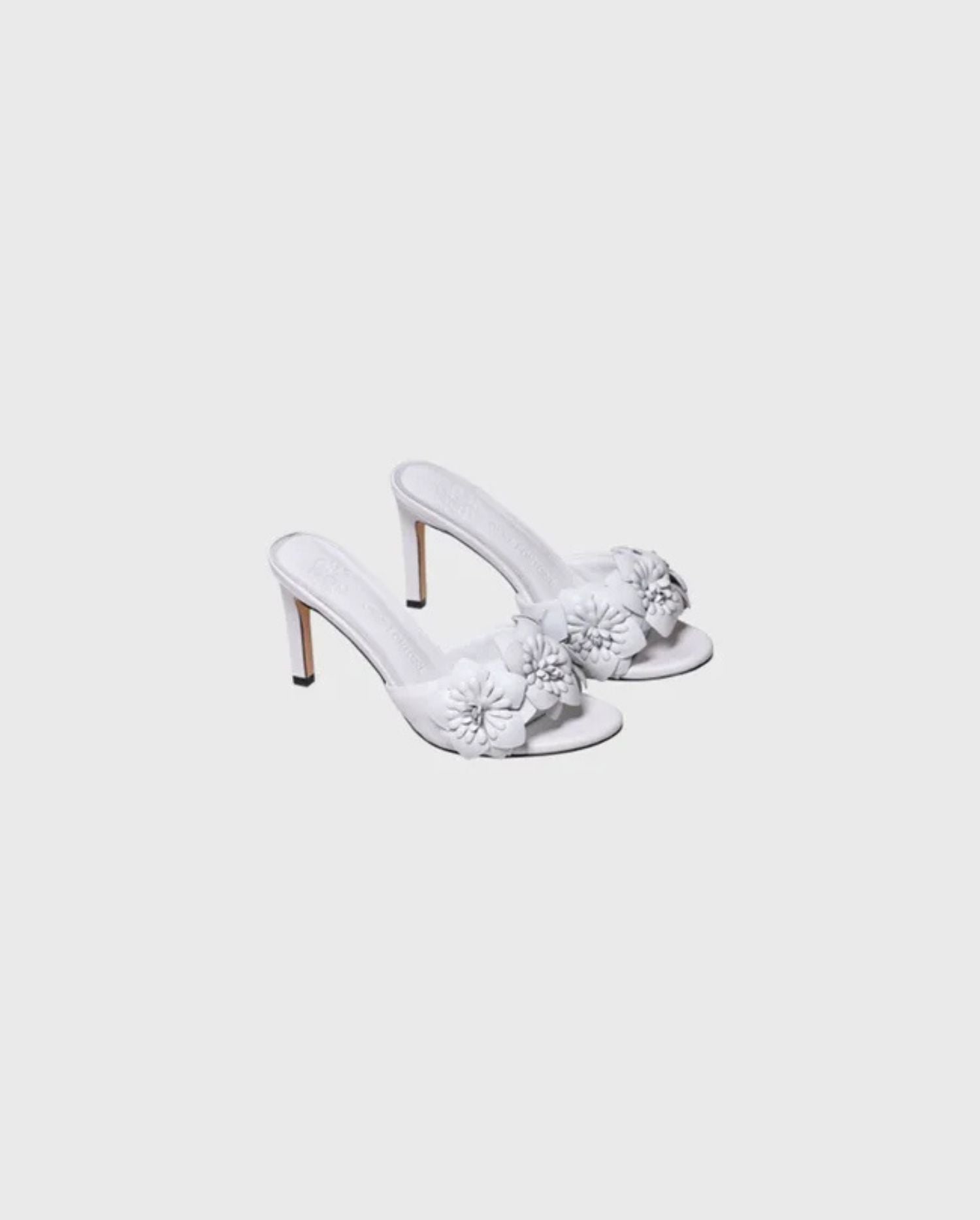 Discover the CAMOMILLE White Leather Sandal Heels With 3D Flowers by designer ANNE FONTAINE
