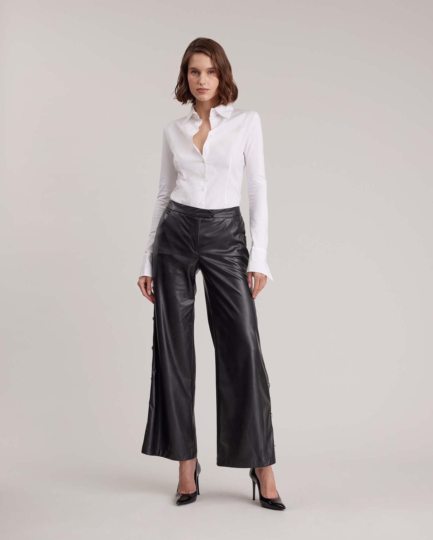 Discover the ESTHETE Wide Leg Faux Leather Pant Featuring Side Snap Details