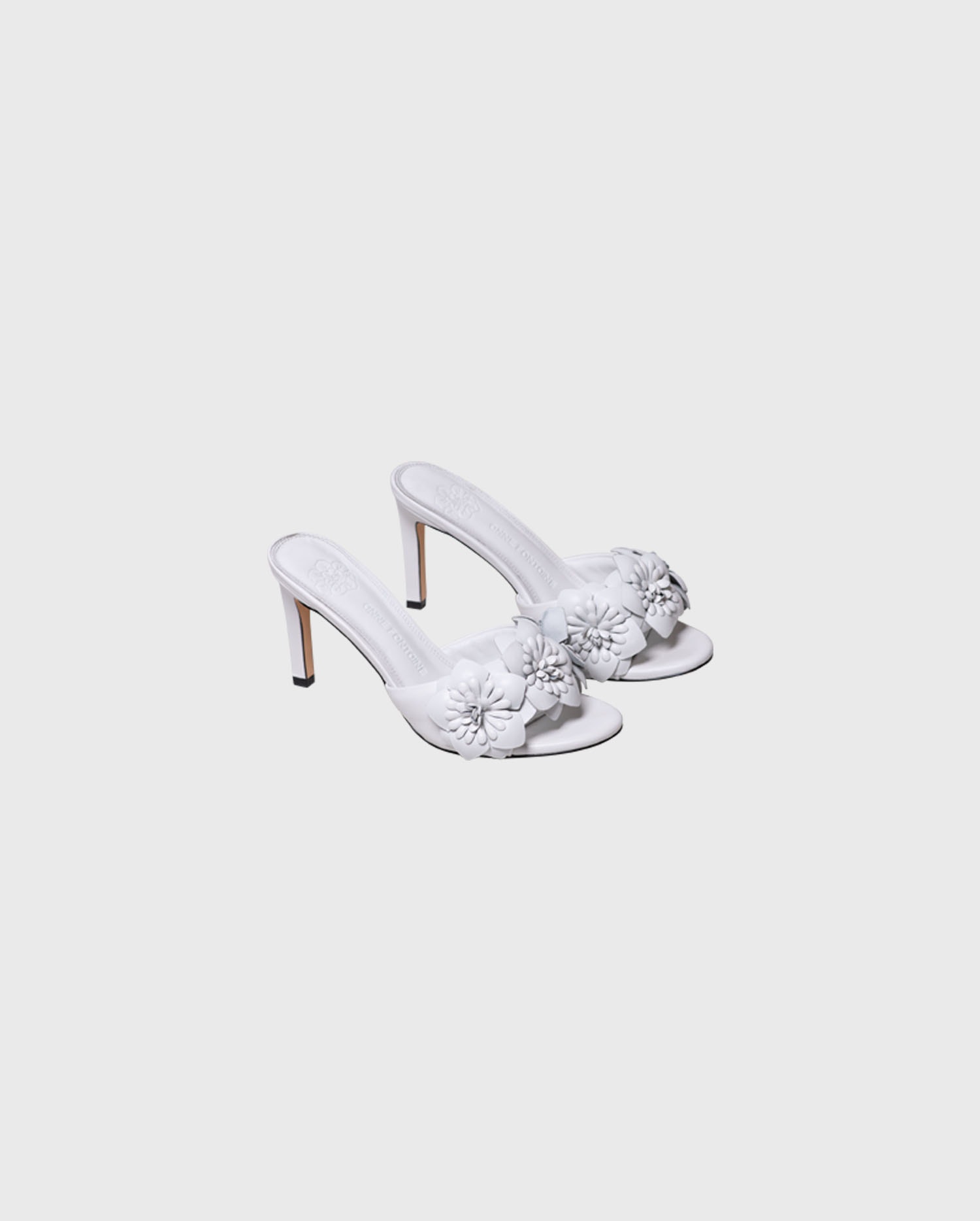 Shop the CAMOMILLE White leather sandal heels with 3D flowers from designer ANNE FONTAINE