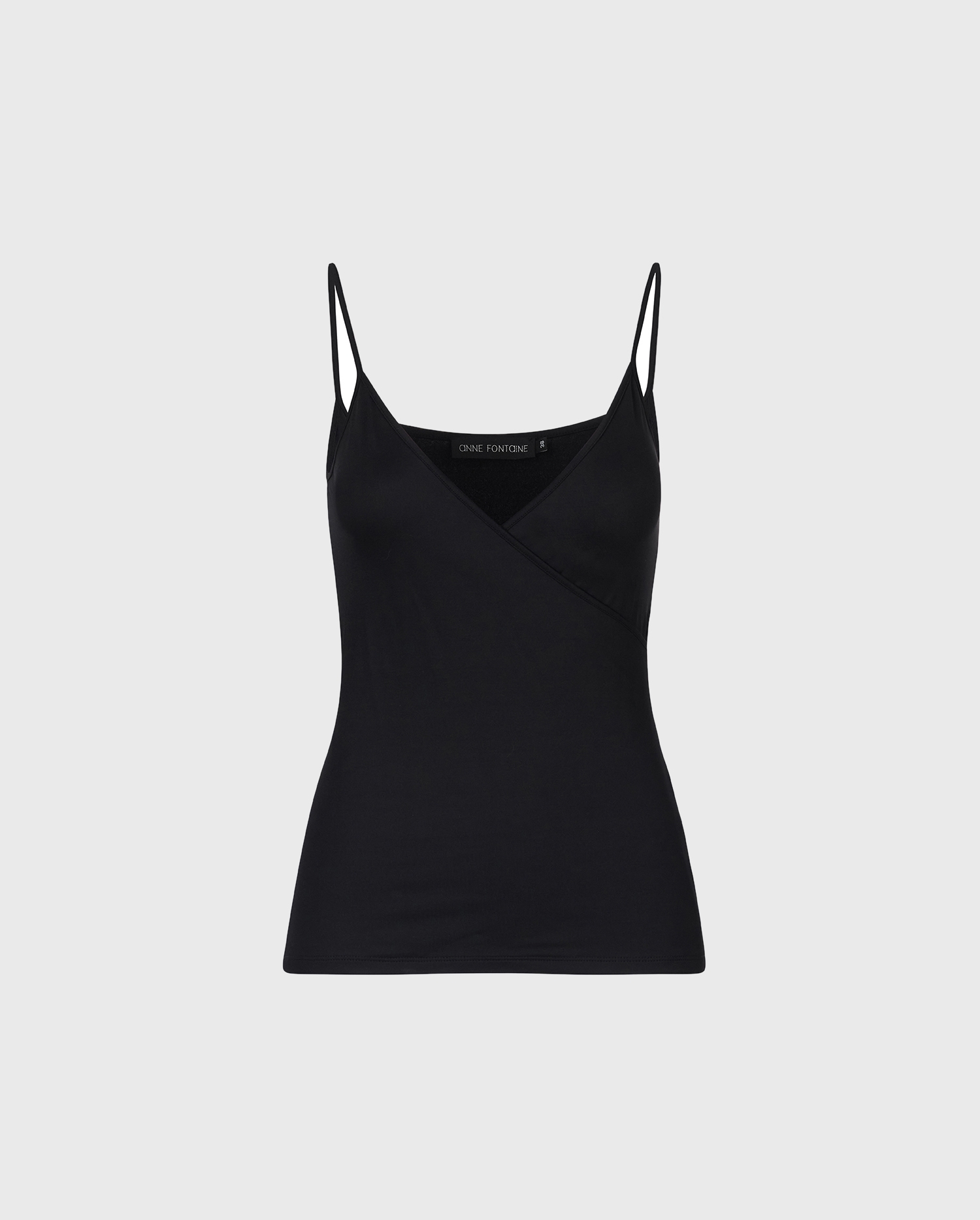 The black crossover CINA camisole to is the perfect essential for your Parisian chic wardrobe.