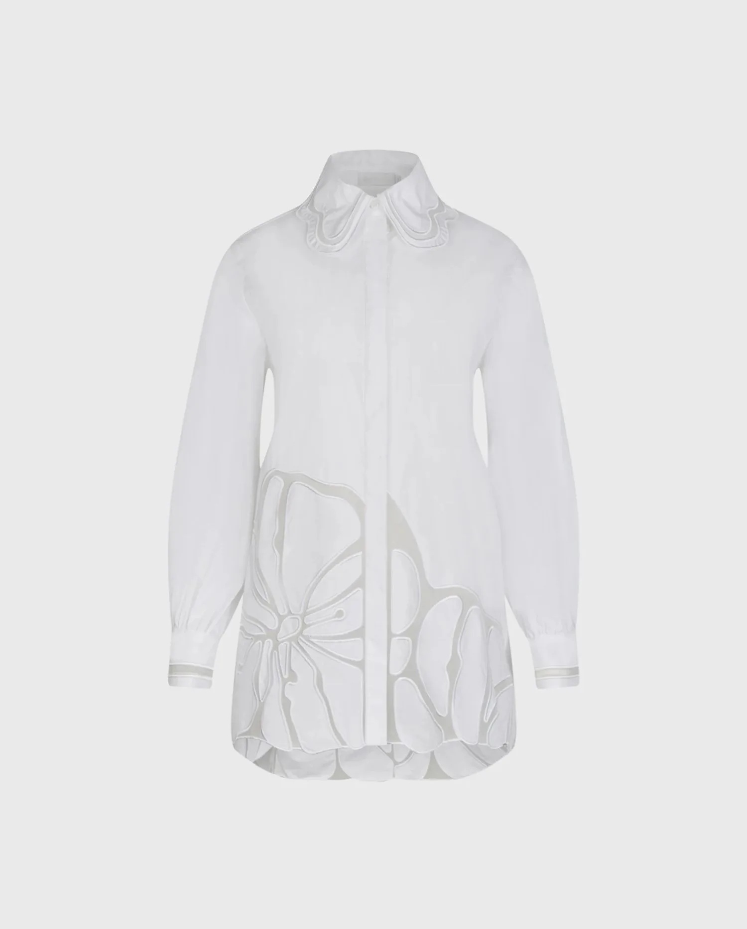 Discover the INGRID White Long Sleeve Poplin Tunic Length Shirt With Sheer Embroidered Flowers Along the Bottom Hem from designer Anne Fontaine