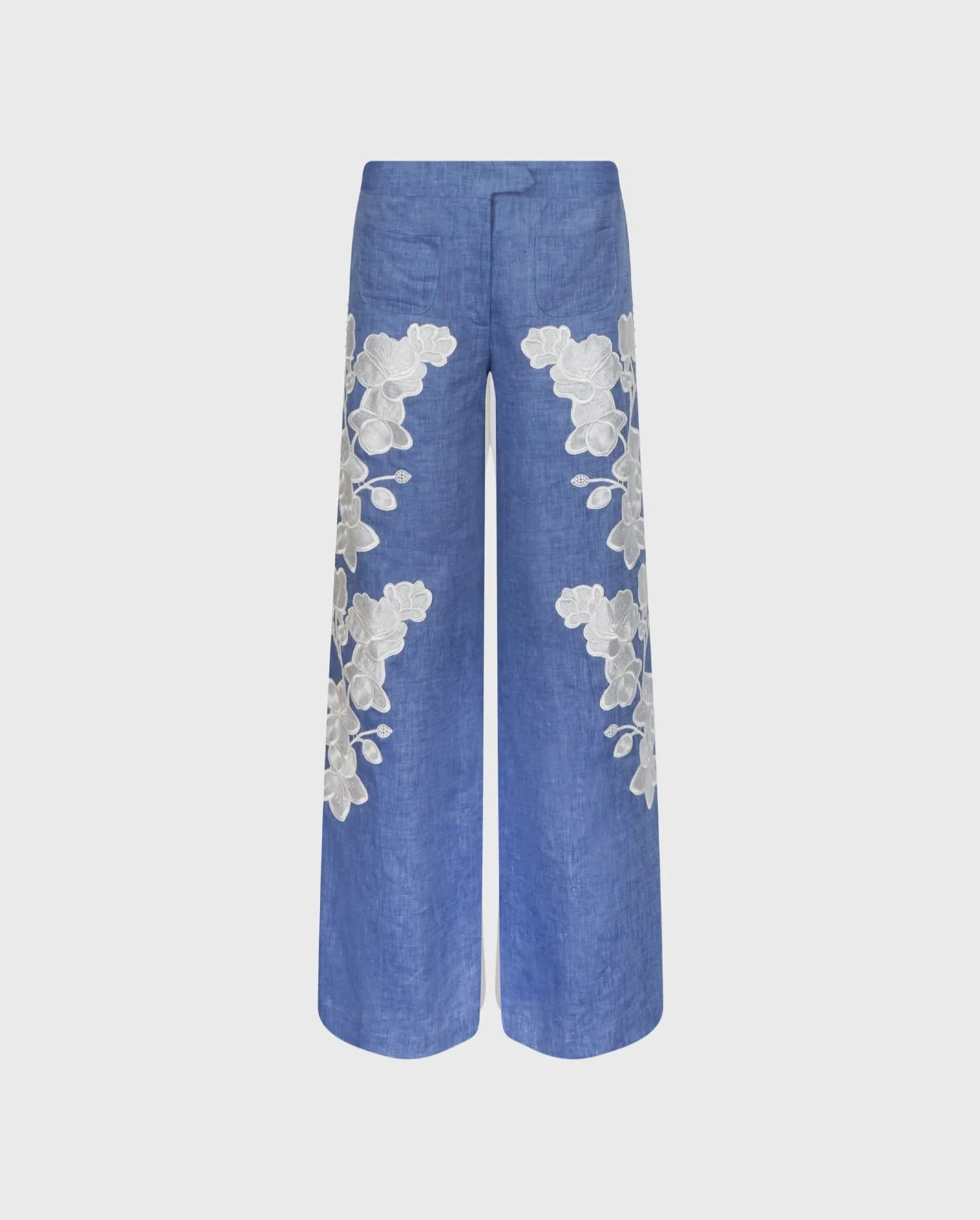 Discover the Jenna Chambray Blue Linen Wide Leg Pants With White Floral Embroidery And Pearl Buttons Side Detailing from designer ANNE FONTAINE