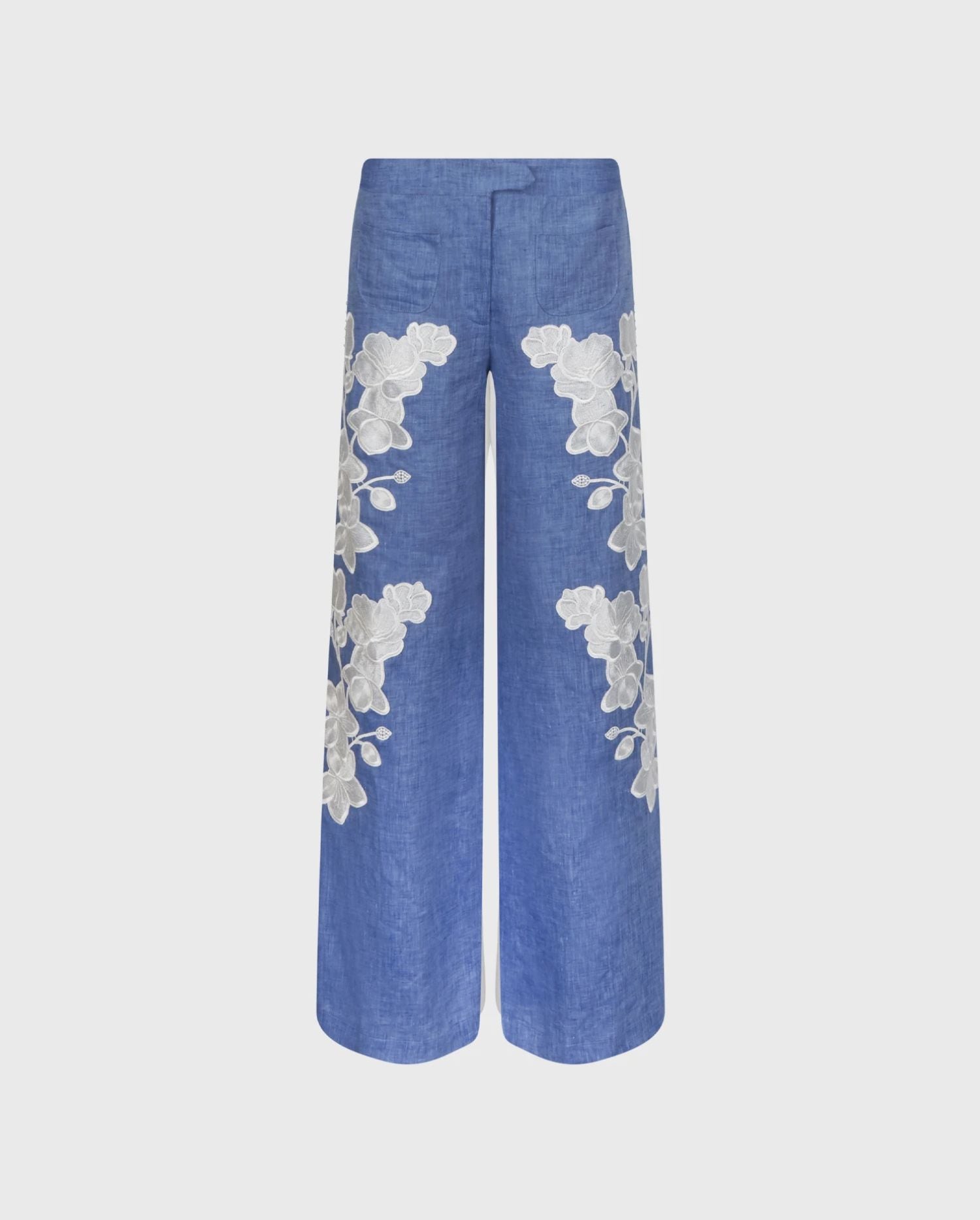 Discover the Jenna Chambray Blue Linen Wide Leg Pants With White Floral Embroidery And Pearl Buttons Side Detailing from designer ANNE FONTAINE