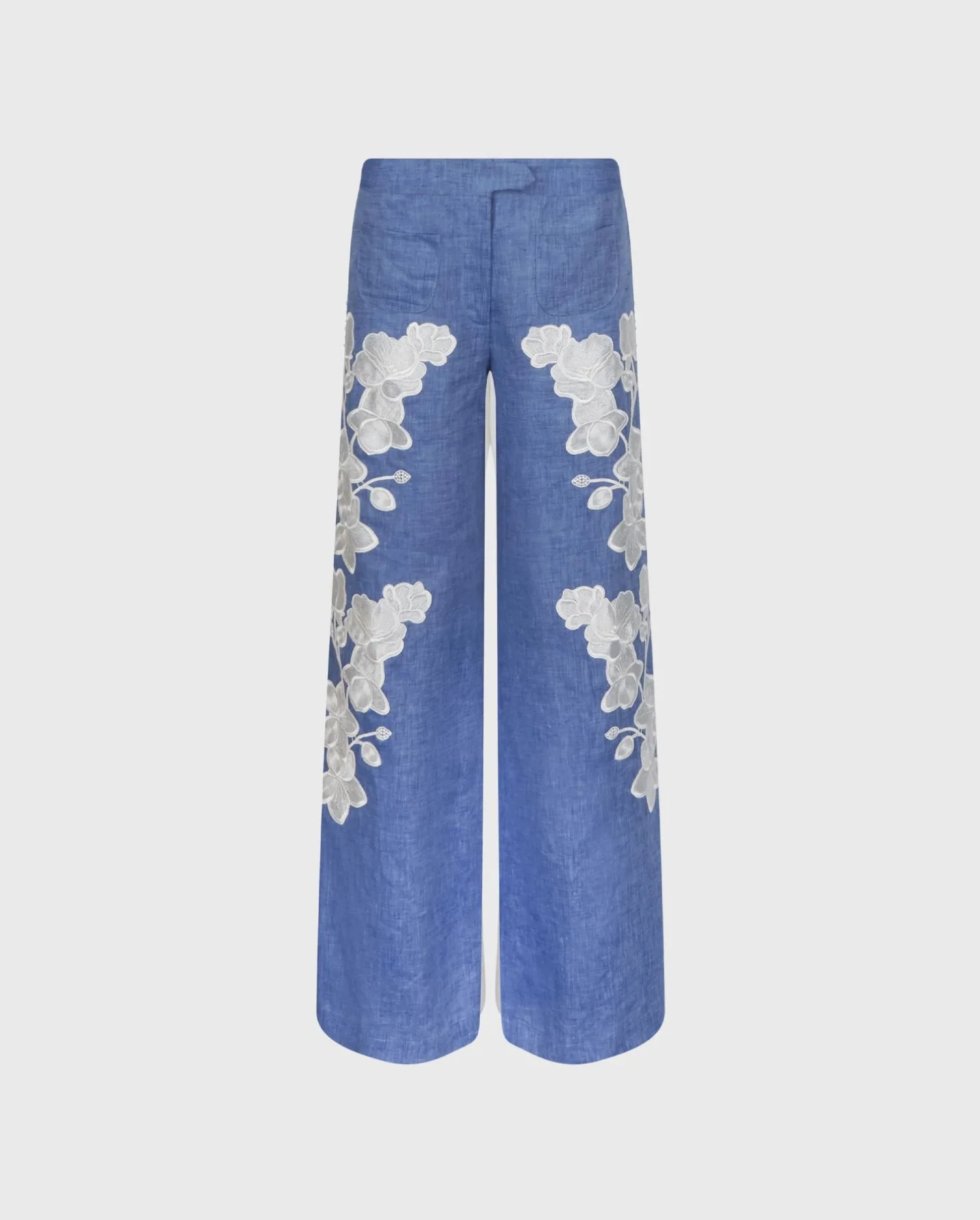 Discover the JENNA Chambray Blue Linen Wide Leg Pants With White Floral Embroidery And Pearl Buttons Side Detailing by designer ANNE FONTAINE