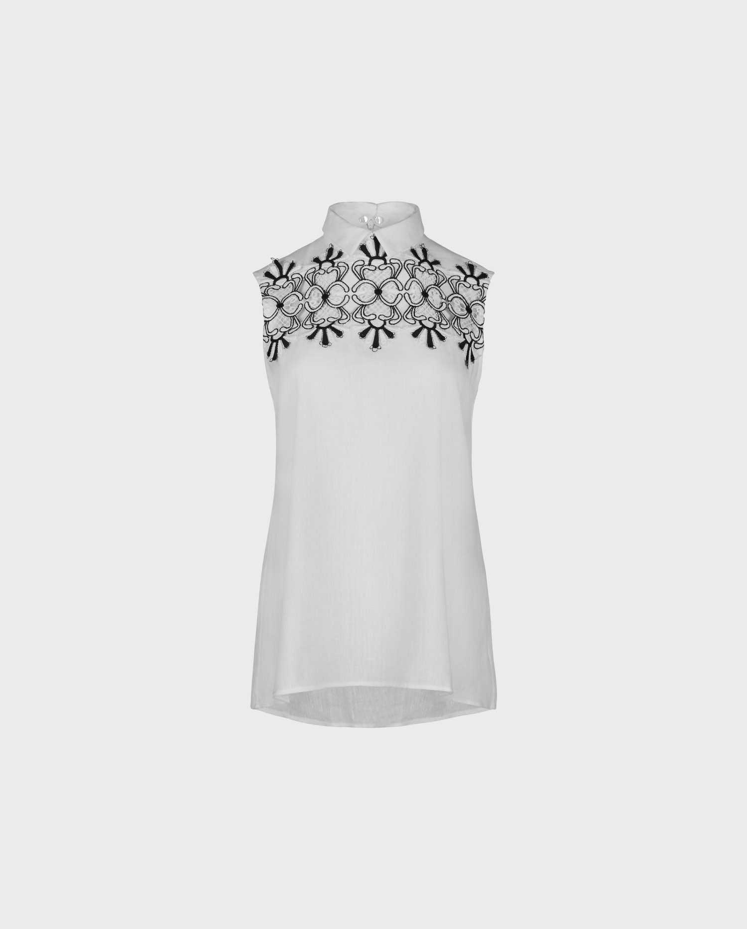 Explore the LAUBURU  white linen sleeveless collared top with intricate black open lacework throughout the yoke