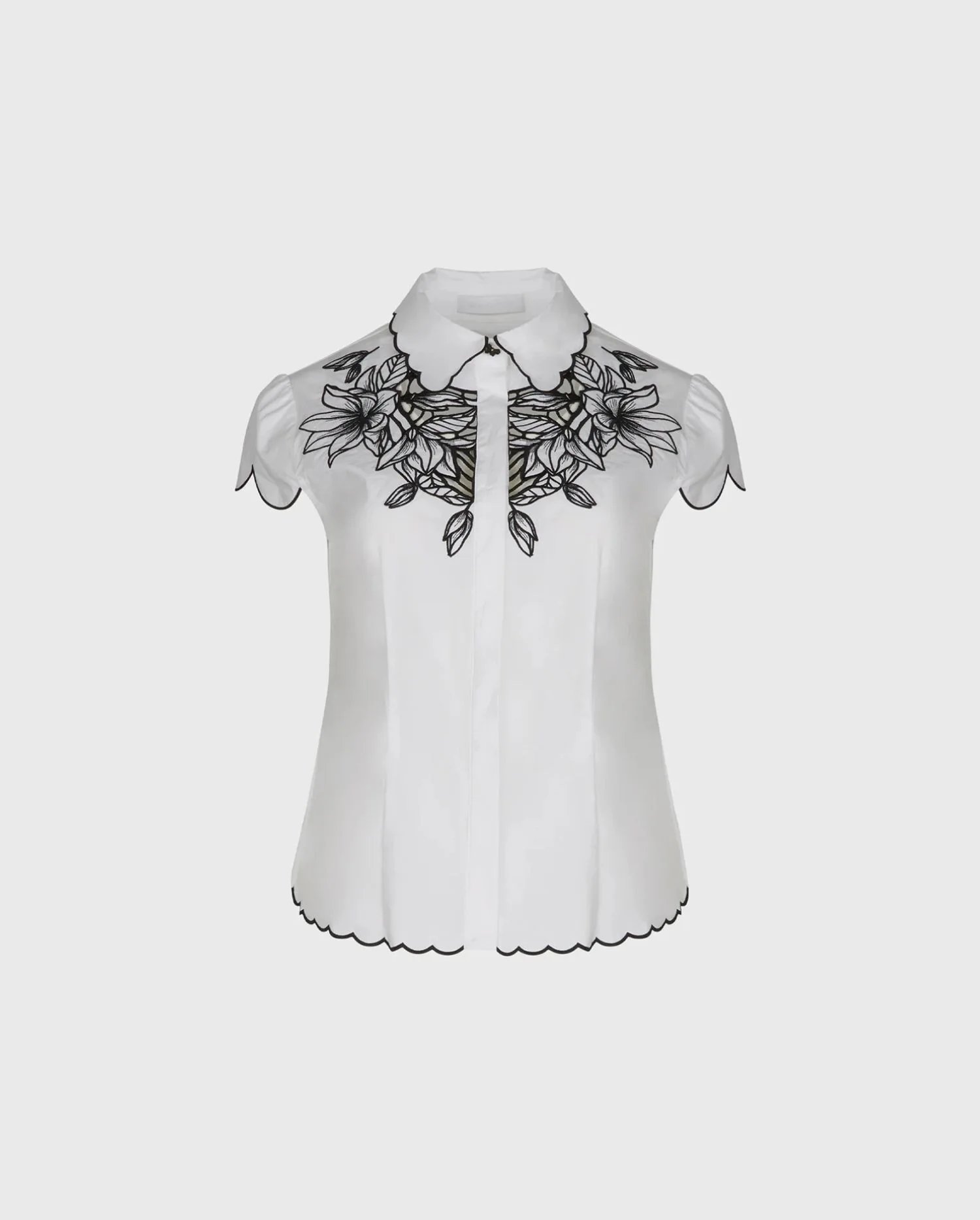Discover the Luisa White Short Sleeve Poplin Shirt With Black Floral Embroidered Design from designer ANNE FONTAINE